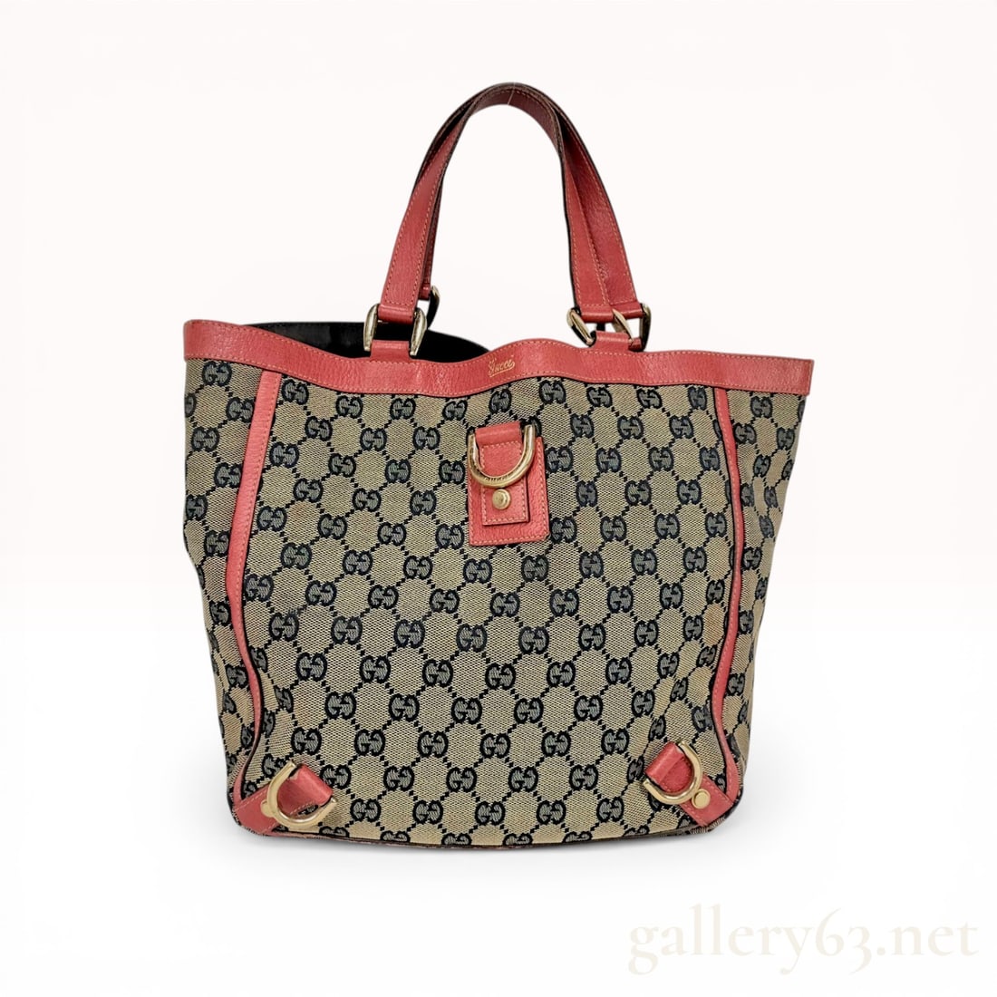 Gucci Abbey D-Ring Monogram Canvas Tote Bag: Gucci Abbey D-Ring tote bag featuring the signature GG monogram canvas in beige and ebony. The exterior is accented with coral-toned textured leather trim, dual flat handles, and gold-tone hardware in