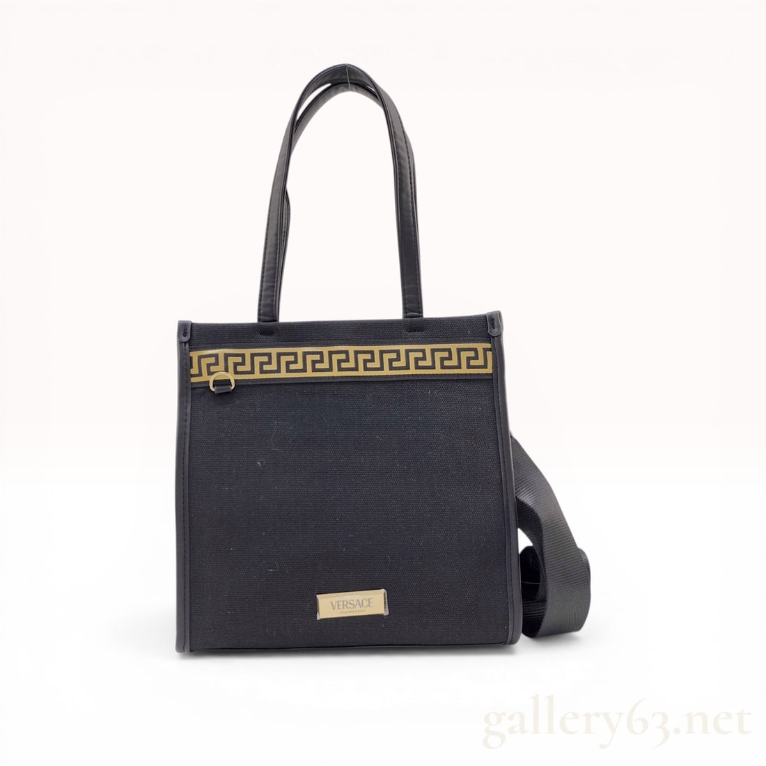 Versace Fragrances Black Canvas and Gold Greca Tote Bag: Versace Fragrances promotional tote bag with a detachable shoulder strap. The bag is constructed from black canvas with synthetic leather trim and handles, featuring a gold and black Greca patterned b