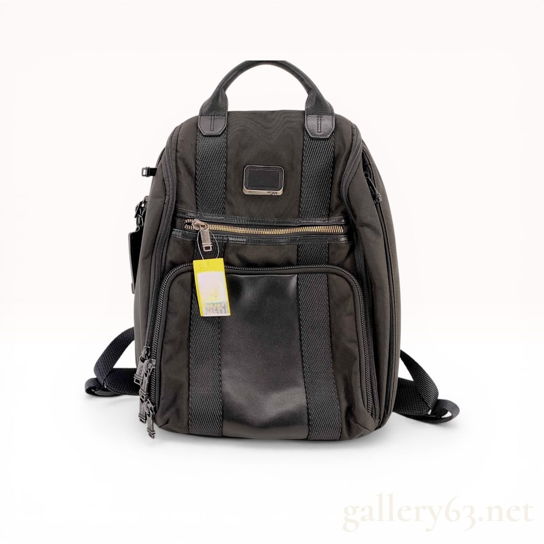 Tumi Alpha Bravo Tyndall Laptop Backpack in Black Ballistic Nylon: Tumi Alpha Bravo Tyndall backpack, model 232632D, constructed from durable FXT ballistic nylon with black leather trim and gunmetal-tone hardware. The exterior features multiple zippered compartments,