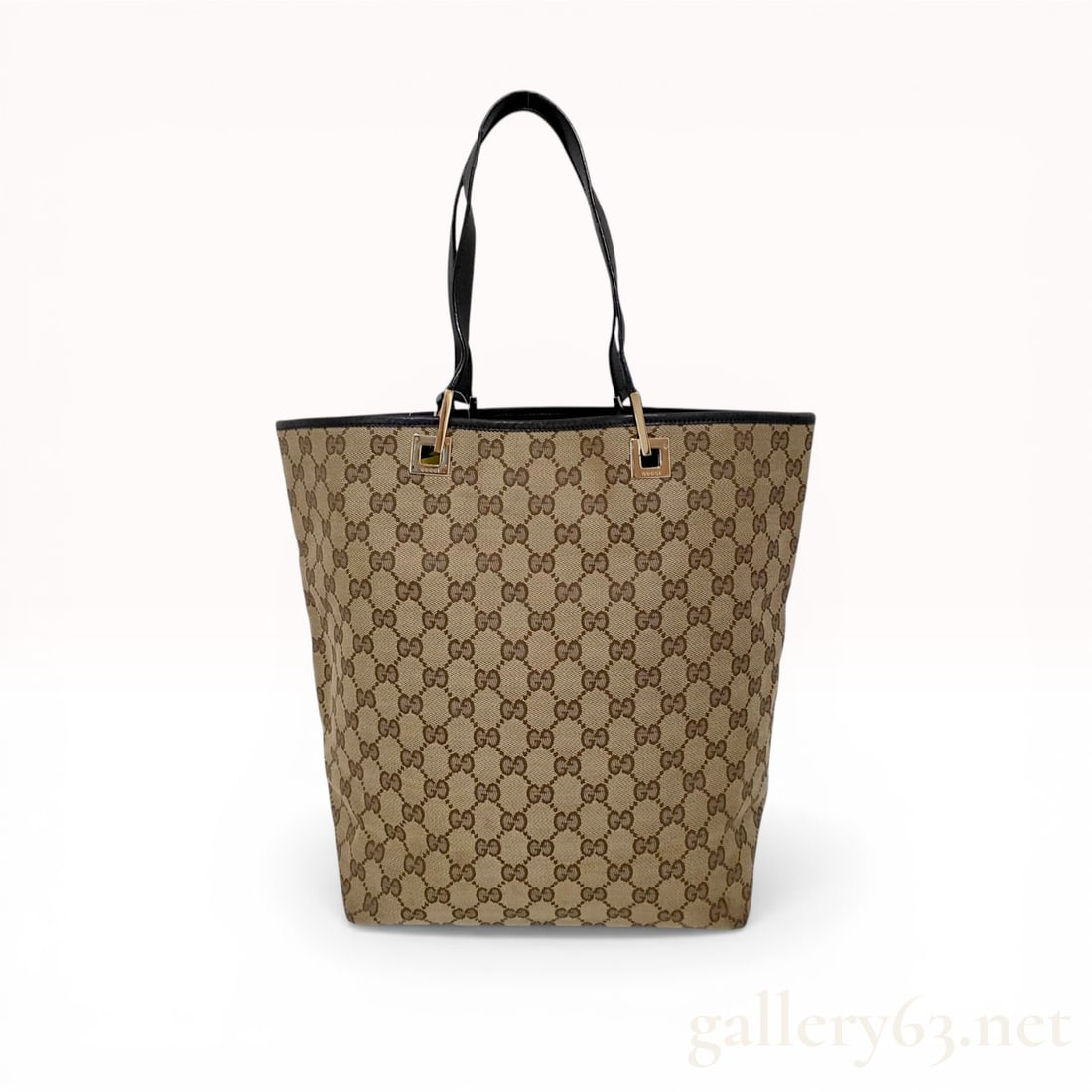 Gucci GG Canvas Tote Bag with Brown Leather Trim: Gucci GG monogram canvas tote bag, late 20th century. Features beige and ebony GG canvas with dark brown leather handles, top trim, and a reinforced leather base. Gold-tone square hardware is stamped
