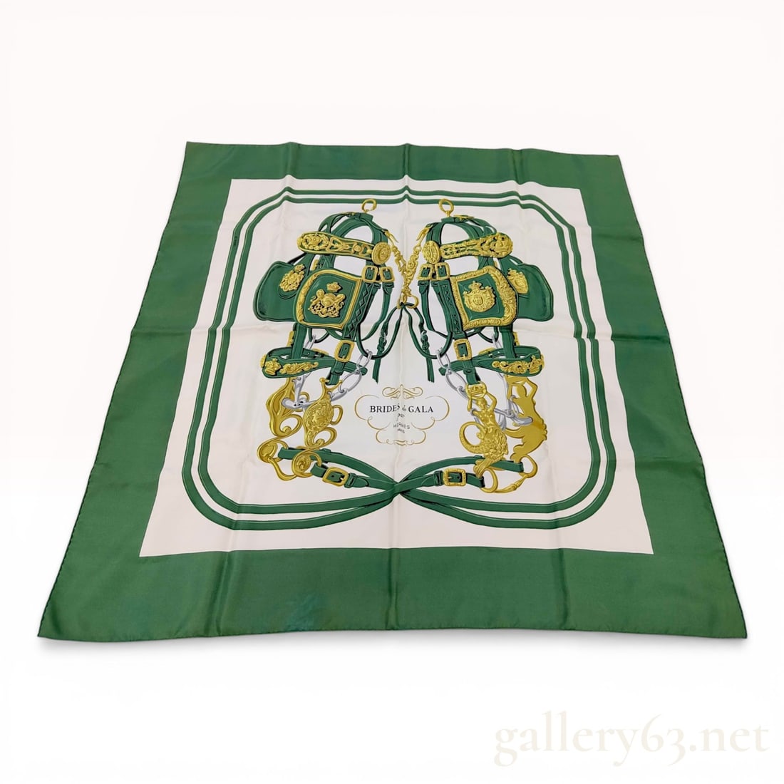 Hermes Brides de Gala Silk Scarf in Forest Green and Cream: Hermes silk twill carre in the Brides de Gala pattern designed by Hugo Grygkar. The design features equestrian bridles with gold and silver-tone hardware on a cream field with a wide forest green bord