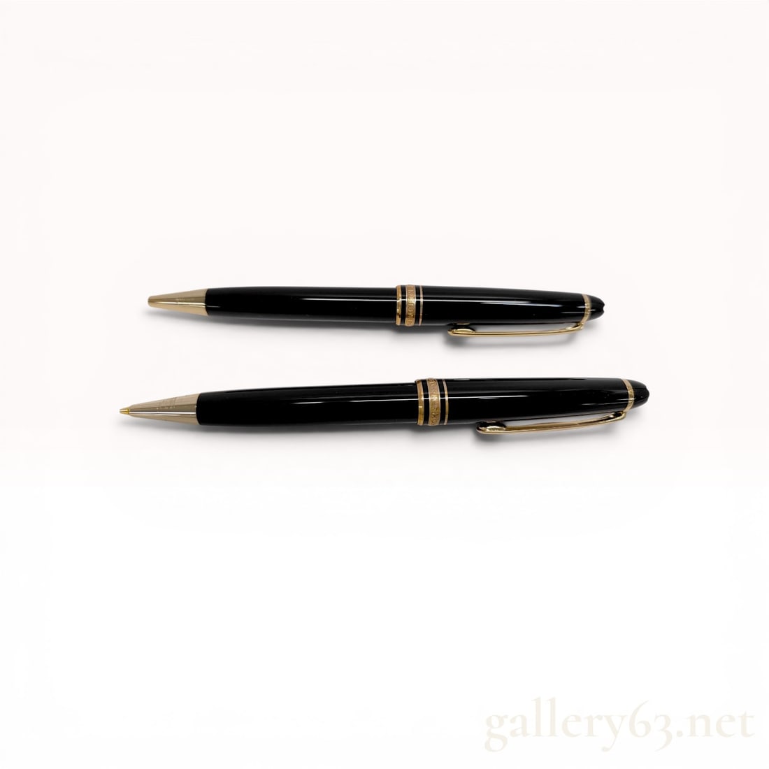 A Pair of Montblanc Meisterstuck Classique Gold-Coated Resin Writing Instruments: Montblanc Meisterstuck Classique ballpoint pen and mechanical pencil set with a black leather two-pen folding pouch. Both instruments feature black precious resin barrels with gold-plated trim and the