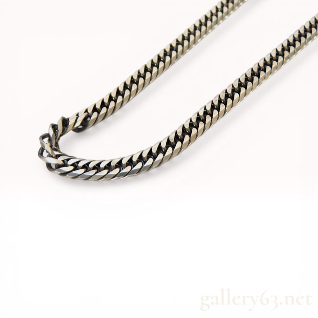 Leda Silma Silver and Germanium Alloy Kihei Curb Link Chain Necklace: Leda Silma Kihei style curb link chain necklace composed of a silver and germanium alloy. The necklace is secured with a lobster claw clasp and features terminal pieces with various markings. These ma