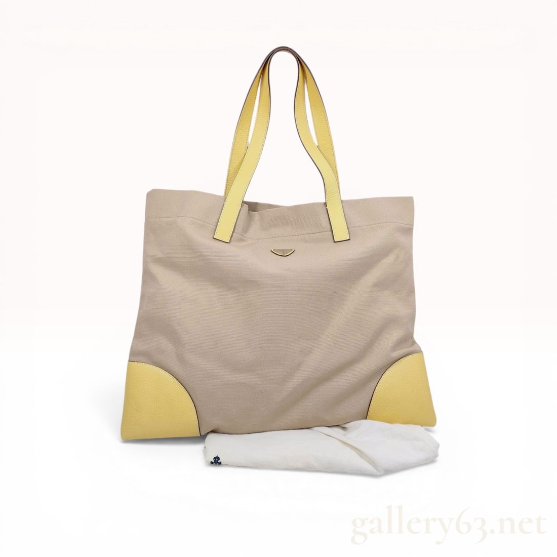 Prada Cinghiale Trimmed Canapa Tote Bag: Prada Cinghiale trimmed Canapa tote bag. This large-format bag features a tan canvas body accented with yellow pebbled leather handles and corner reinforcements. The design includes an open top secure