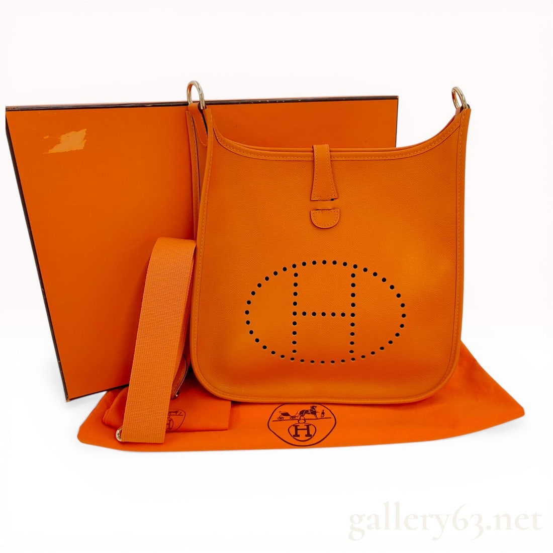 Hermes Evelyne I PM Orange Grained Leather Shoulder Bag: Hermes Evelyne I PM shoulder bag, 2004. This piece is crafted from orange grained leather featuring the signature perforated H logo and gold-tone hardware. The bag includes a detachable canvas shoulde