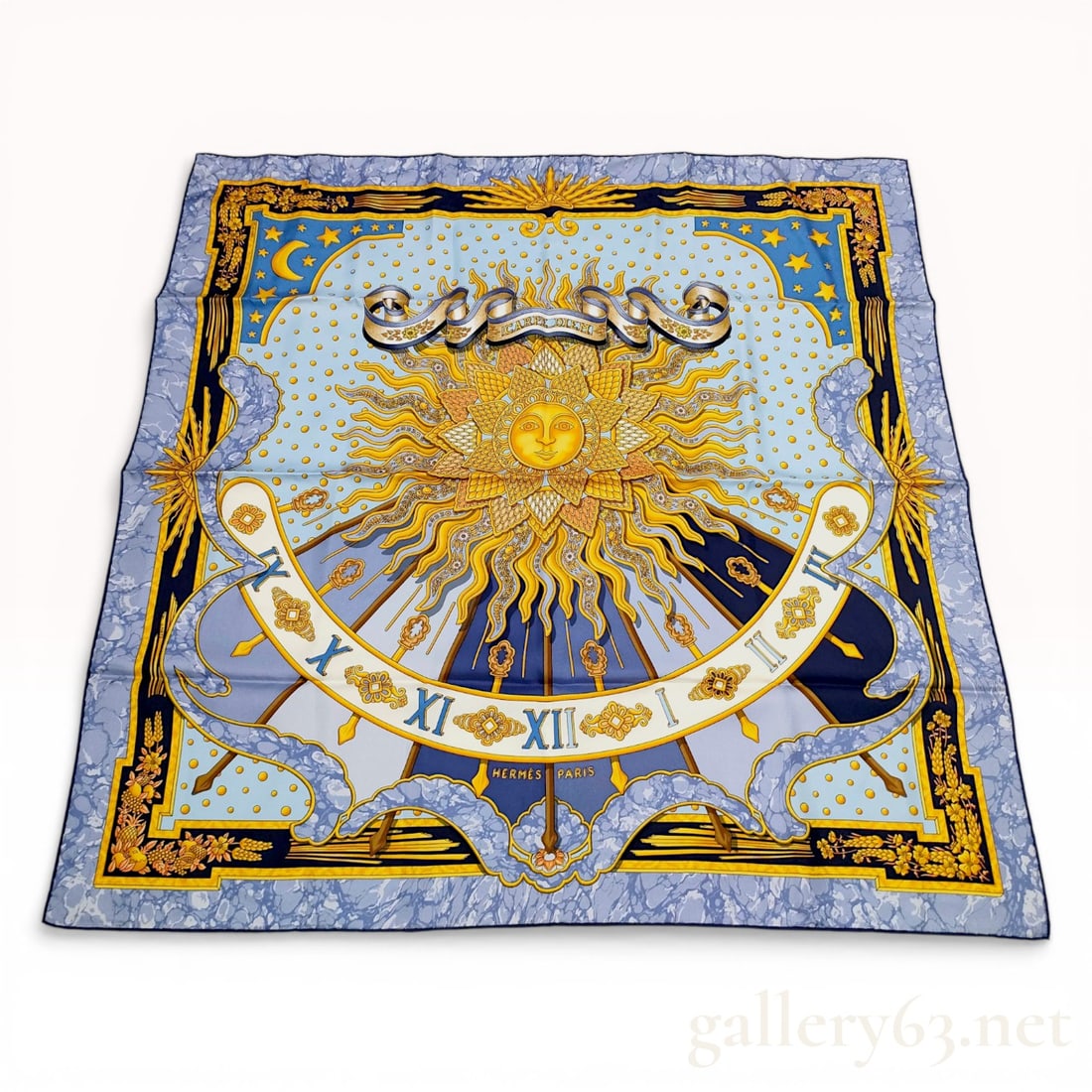 Hermes Carpe Diem Silk Carre 90 Scarf by Joachim Metz: Hermes silk scarf in the Carpe Diem pattern designed by artist Joachim Metz, late 20th century. The 100% silk twill construction features a central anthropomorphic sun motif, sundial, and celestial el