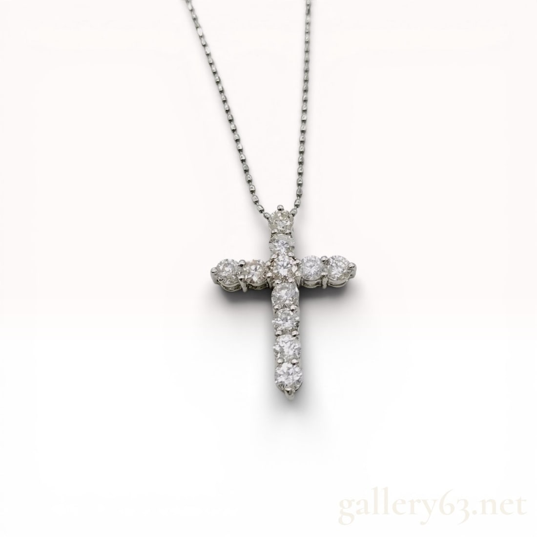 Platinum and Diamond Cross Pendant Necklace: Platinum and diamond cross pendant necklace, contemporary. The Latin cross pendant features eleven prong-set round brilliant-cut diamonds suspended from a platinum bead chain with a spring ring clasp.
