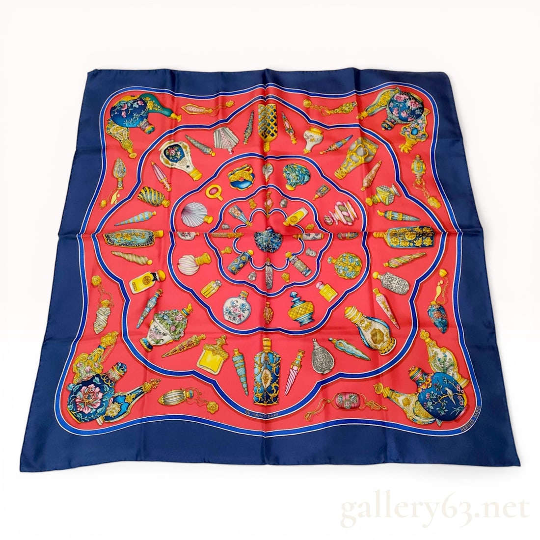 Hermes Qu'importe le flacon Silk Carre 90 Scarf: Hermes silk scarf in the Qu'importe le flacon pattern designed by Catherine Baschet. The screen-printed design features a central red field populated with various antique perfume bottles and flacons,