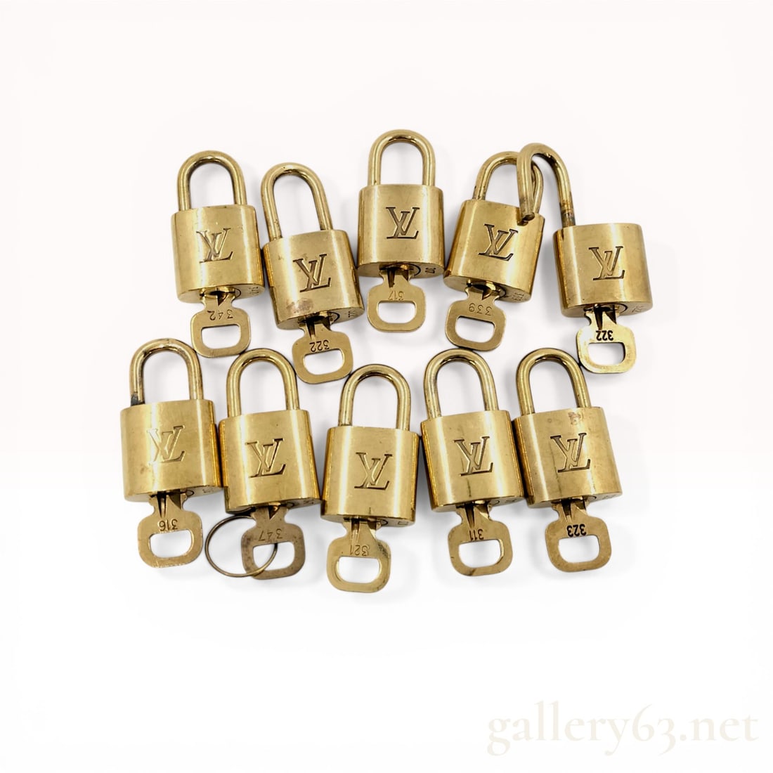 A Set of 10 Louis Vuitton Brass Padlocks and Keys: Louis Vuitton brass padlock and key sets, contemporary. Each solid brass lock features an incised LV monogram on the front face and is stamped on the reverse with the registered trademark symbol, Loui