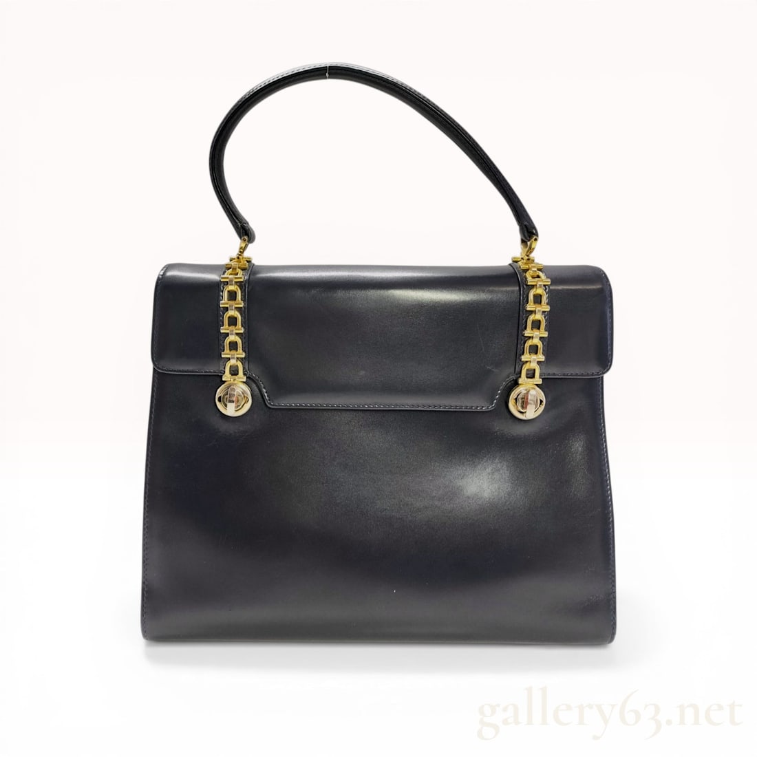Gucci Vintage Navy Box Calf Leather Top-Handle Flap Bag with Horsebit Chain Detail: Gucci vintage top-handle flap bag, mid-20th century. Constructed from dark navy box calf leather, the exterior features gold-tone hardware with horsebit-inspired chain accents and four protective base
