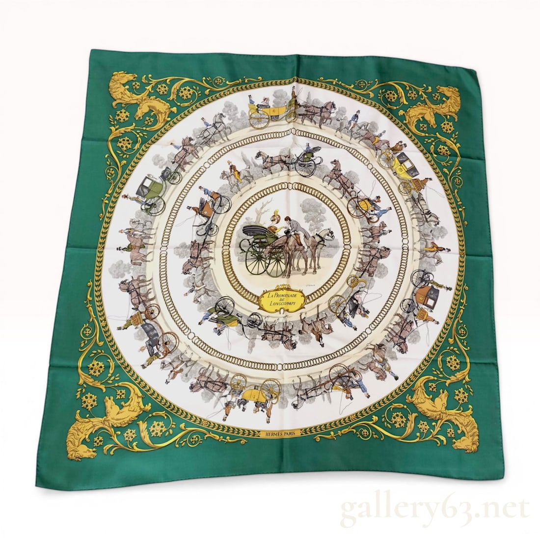 Hermes La Promenade de Longchamps Silk Scarf by Philippe Ledoux: Hermes silk carre in the La Promenade de Longchamps pattern, designed by Philippe Ledoux, originally issued circa 1965. The design features an emerald green border with gold-toned rococo scrollwork an