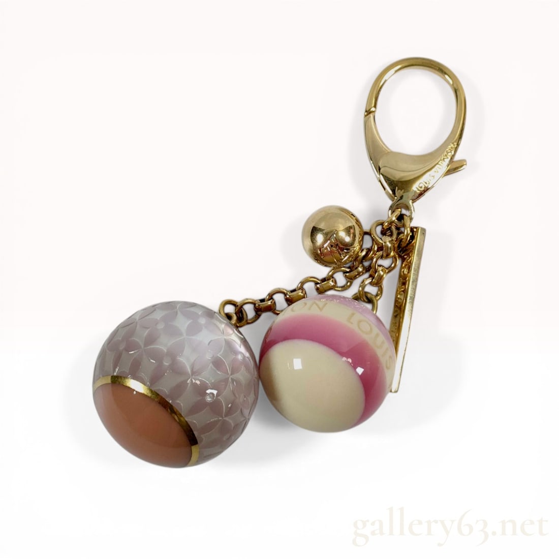 Louis Vuitton Bijoux Sac Mini Lin Bag Charm: Louis Vuitton Bijoux Sac Mini Lin bag charm and key holder. The accessory features two decorative resin spheres and a small gold-tone metal sphere suspended from link chains. The larger sphere display