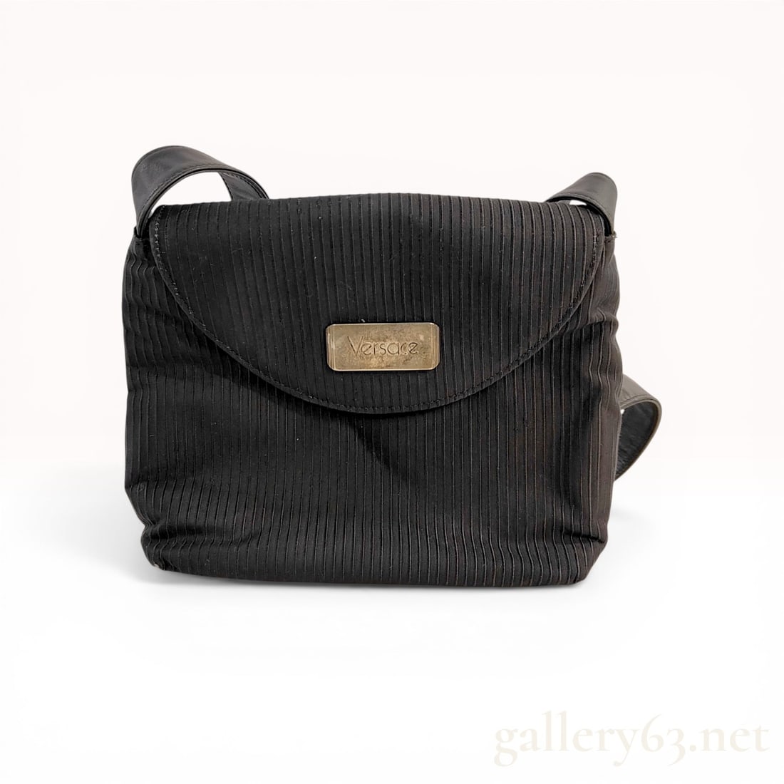 Versace Vintage Ribbed Textile and Leather Shoulder Bag: Versace vintage flap-front shoulder bag. The exterior is constructed from a black ribbed textile featuring a rounded flap with a magnetic snap closure and a wide, adjustable black leather shoulder str