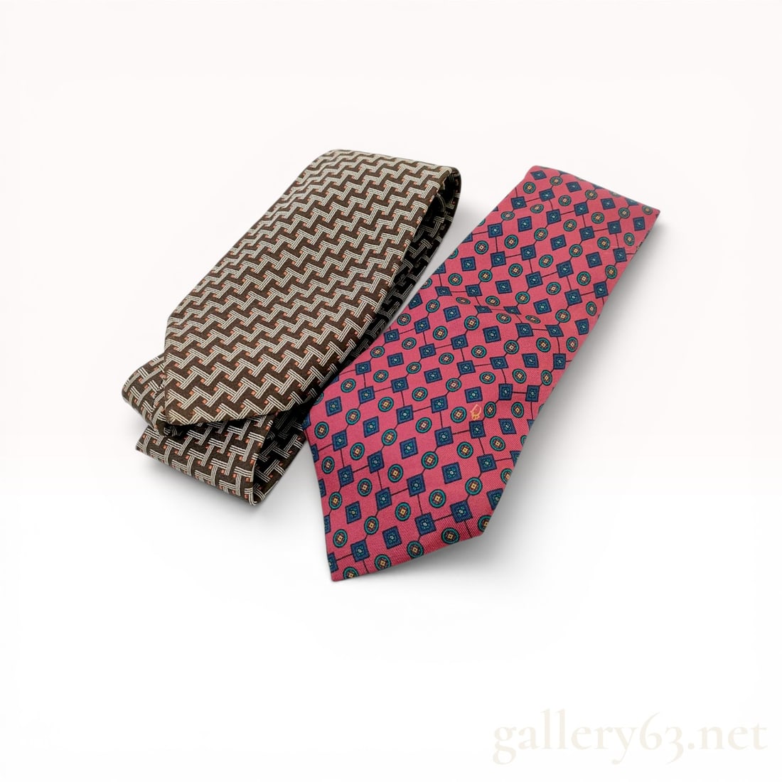Two Christian Dior Monsieur Silk Neckties: Two silk neckties by Christian Dior Monsieur featuring distinct woven and printed patterns. One tie displays a brown and beige geometric basketweave pattern with small orange accents and includes a wh
