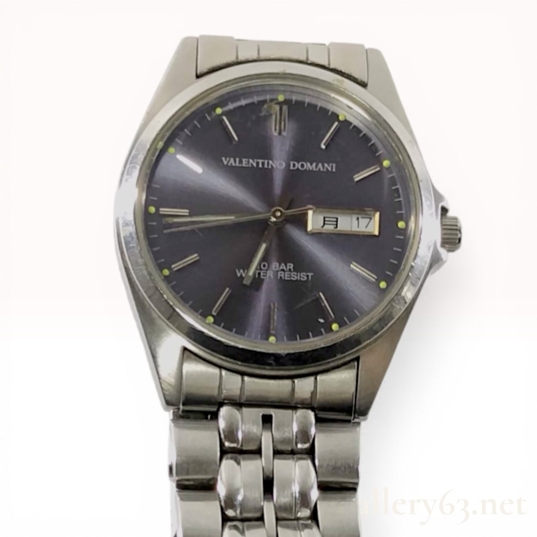 Valentino Domani Stainless Steel Day-Date Wrist Watch: Valentino Domani men's wrist watch featuring a stainless steel case and integrated multi-link bracelet. The navy blue sunray dial is designed with applied baton markers, luminous hands, and a day-date