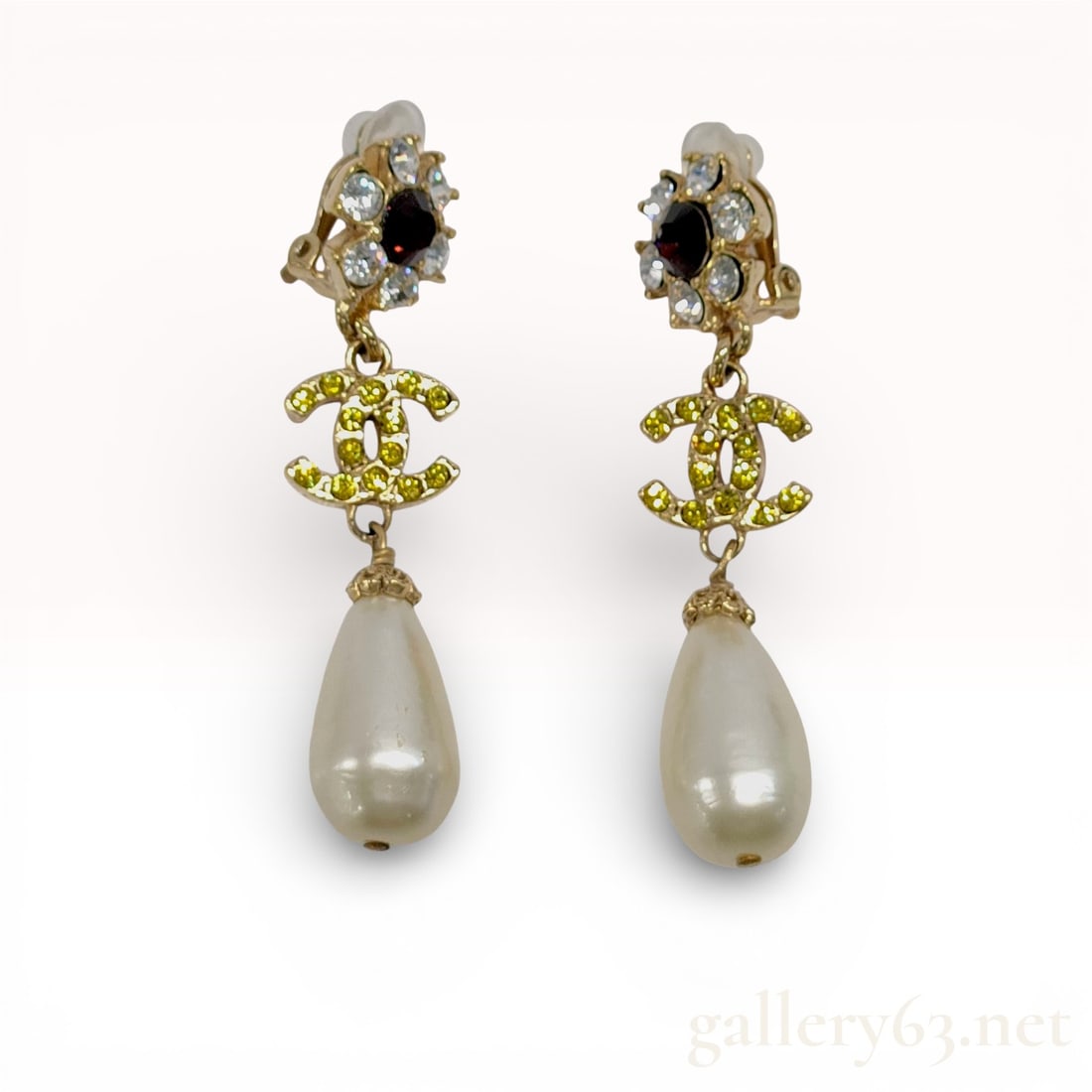 A Pair of Chanel Autumn 2005 Crystal and Faux Pearl CC Logo Drop Earrings: Chanel matched pair of clip-on drop earrings from the Autumn 2005 collection. Each earring features a floral-motif cluster with a central purple faceted stone and clear crystals, an interlocking CC lo