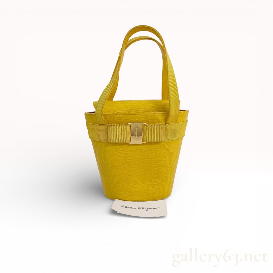 Salvatore Ferragamo Vara Bow Mini Bucket Bag in Yellow Lizard-Embossed Leather: Salvatore Ferragamo Vara Bow mini bucket bag in yellow lizard-embossed leather. Features a front grosgrain ribbon bow with an engraved gold-tone buckle, dual top handles, and a magnetic snap flap clos