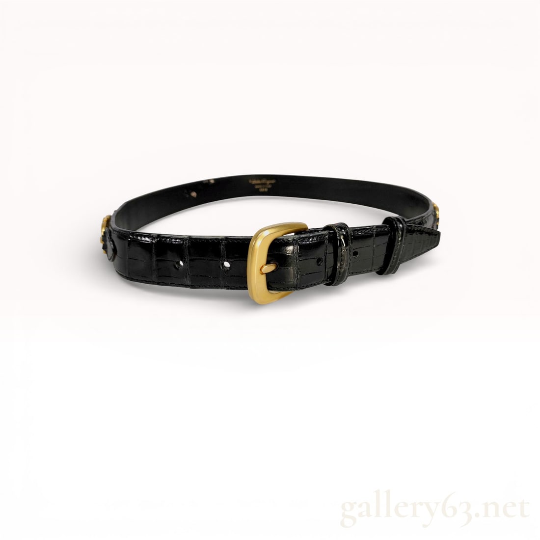 Salvatore Ferragamo Black Crocodile Leather Gancini Belt: Salvatore Ferragamo waist belt, Made in Italy. Constructed from high-shine black crocodile leather with a smooth leather lining and gold-tone hardware including decorative Gancini links engraved with