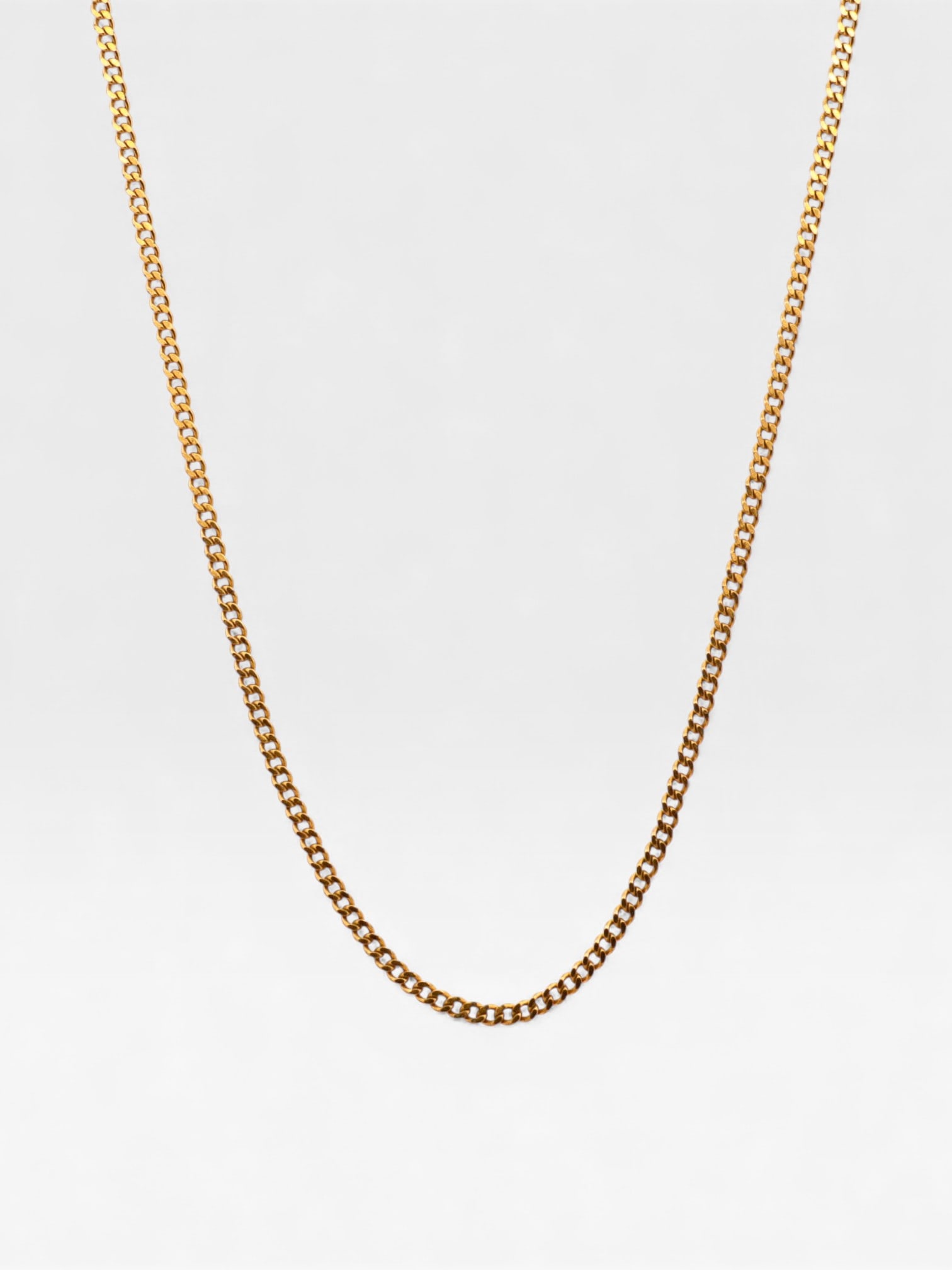 Chanel Gold-Plated Flat Curb Link Chain Necklace: Chanel flat curb link chain necklace, vintage. The piece is crafted from gold-plated metal and features a functional spring ring clasp. An oval hang tag is present, bearing the Chanel copyright and tr