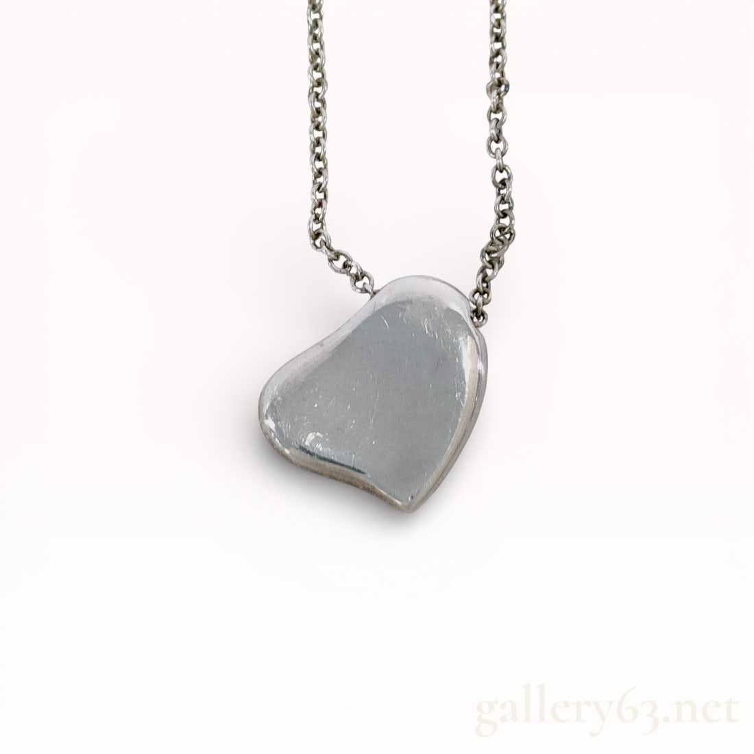 Tiffany & Co. Elsa Peretti Sterling Silver Full Heart Pendant Necklace: Tiffany & Co. sterling silver pendant necklace in the Elsa Peretti Full Heart pattern. The piece features an asymmetrical heart pendant suspended from a delicate cable chain with a spring ring cla