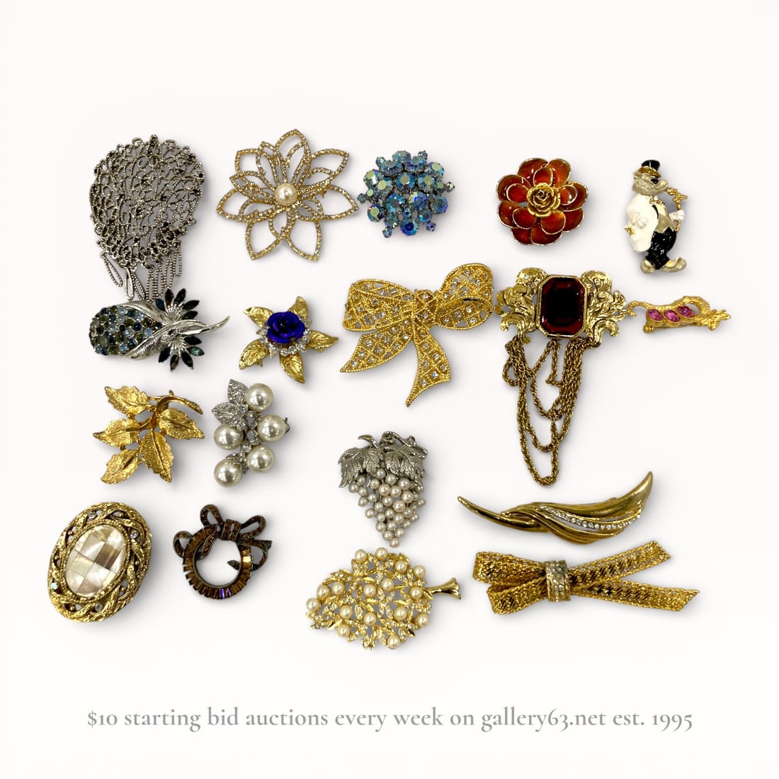 An Assortment of 18 Vintage and Contemporary Costume Jewelry Brooches: An assortment of 18 vintage and contemporary costume jewelry brooches, mid-to-late 20th century. The collection features floral, botanical, figural, and abstract motifs including grape clusters, bows,
