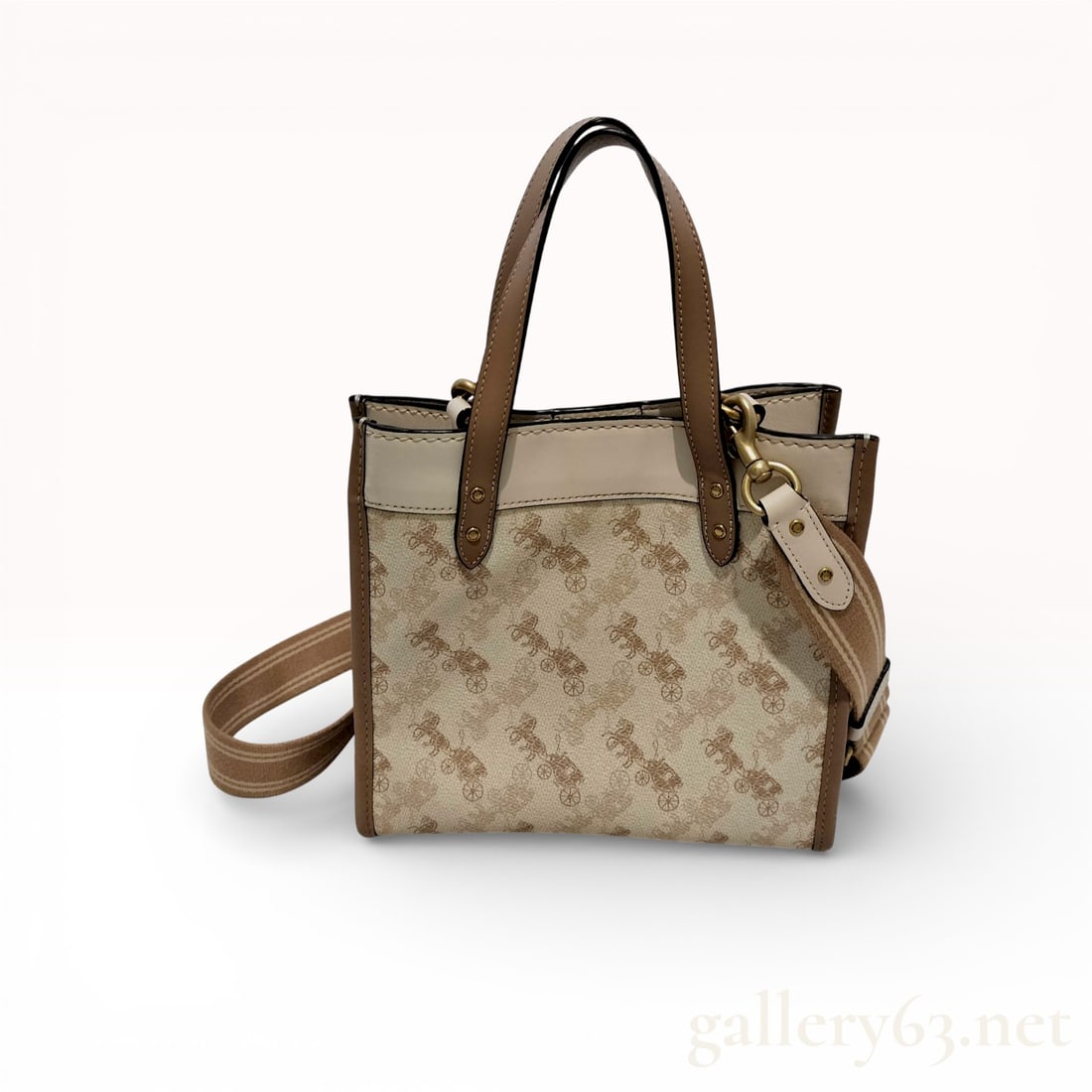 Coach Field Tote 22 with Horse and Carriage Print: Coach Field Tote 22 with Horse and Carriage print, contemporary. Constructed from chalk-colored coated canvas with tan leather trim, the bag features rolled top handles and a detachable striped webbed