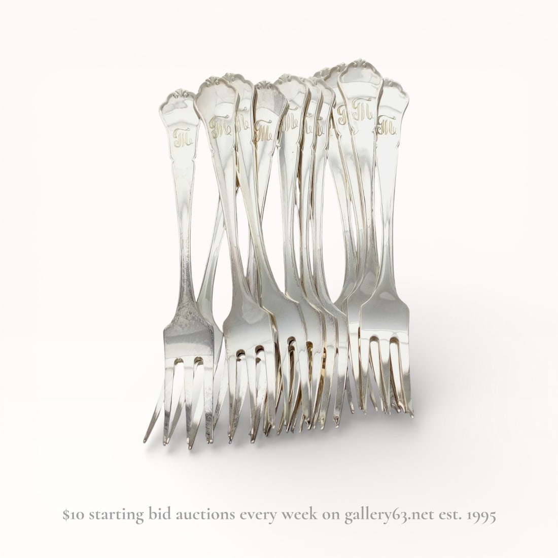 A Set of Nine 830 Silver Three-Tine Forks with Shell Terminals, Late 19th-early 20th C.: A set of nine 830 silver forks featuring a three-tine design, likely for fish or dessert service, dating to the late 19th or early 20th century. Each handle is decorated with a scalloped shell termina