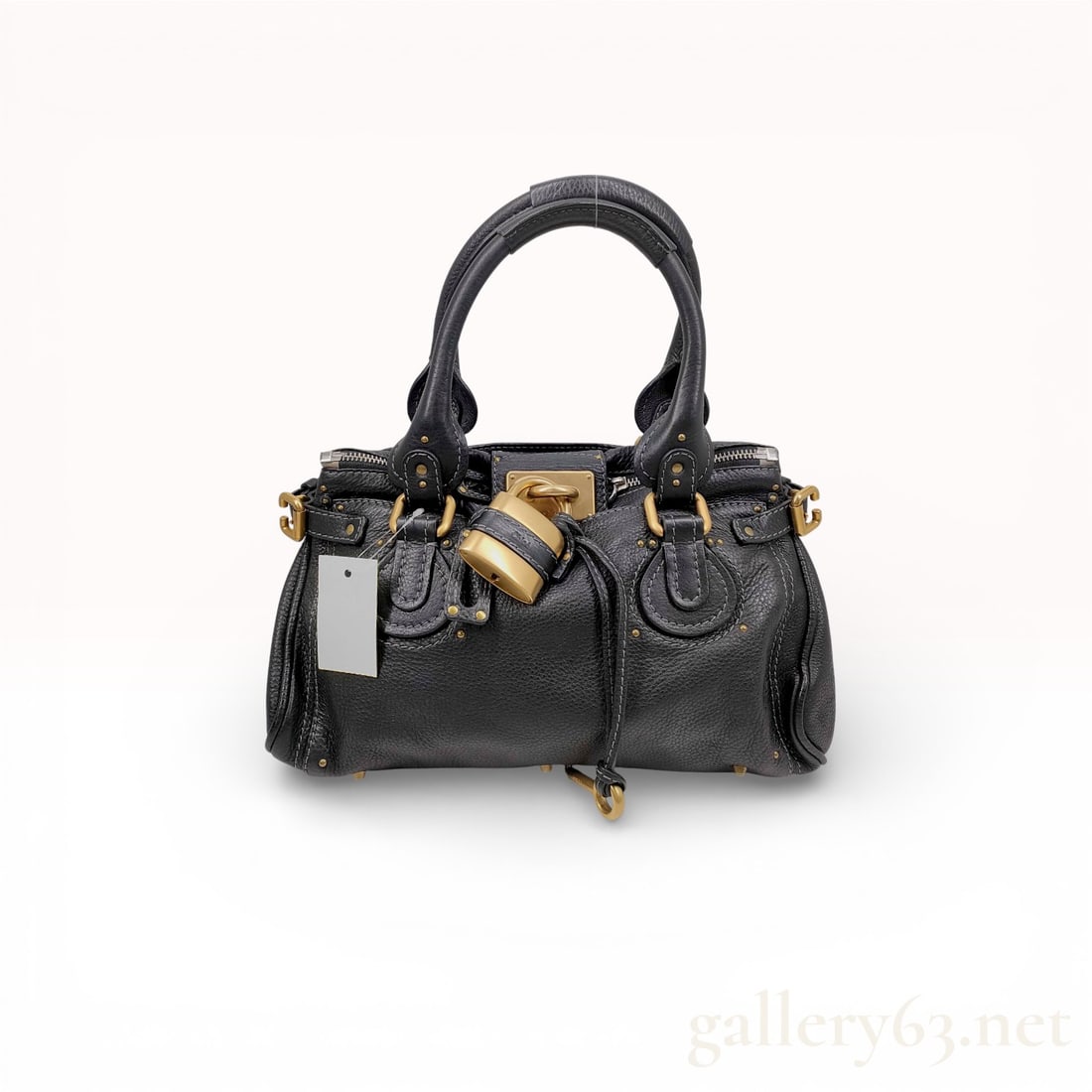 Chloe Paddington Black Leather Satchel: Chloe Paddington leather satchel, circa 2005. Crafted from black pebbled calfskin with contrast grey stitching, the bag features signature oversized antiqued brass-tone hardware including a functional