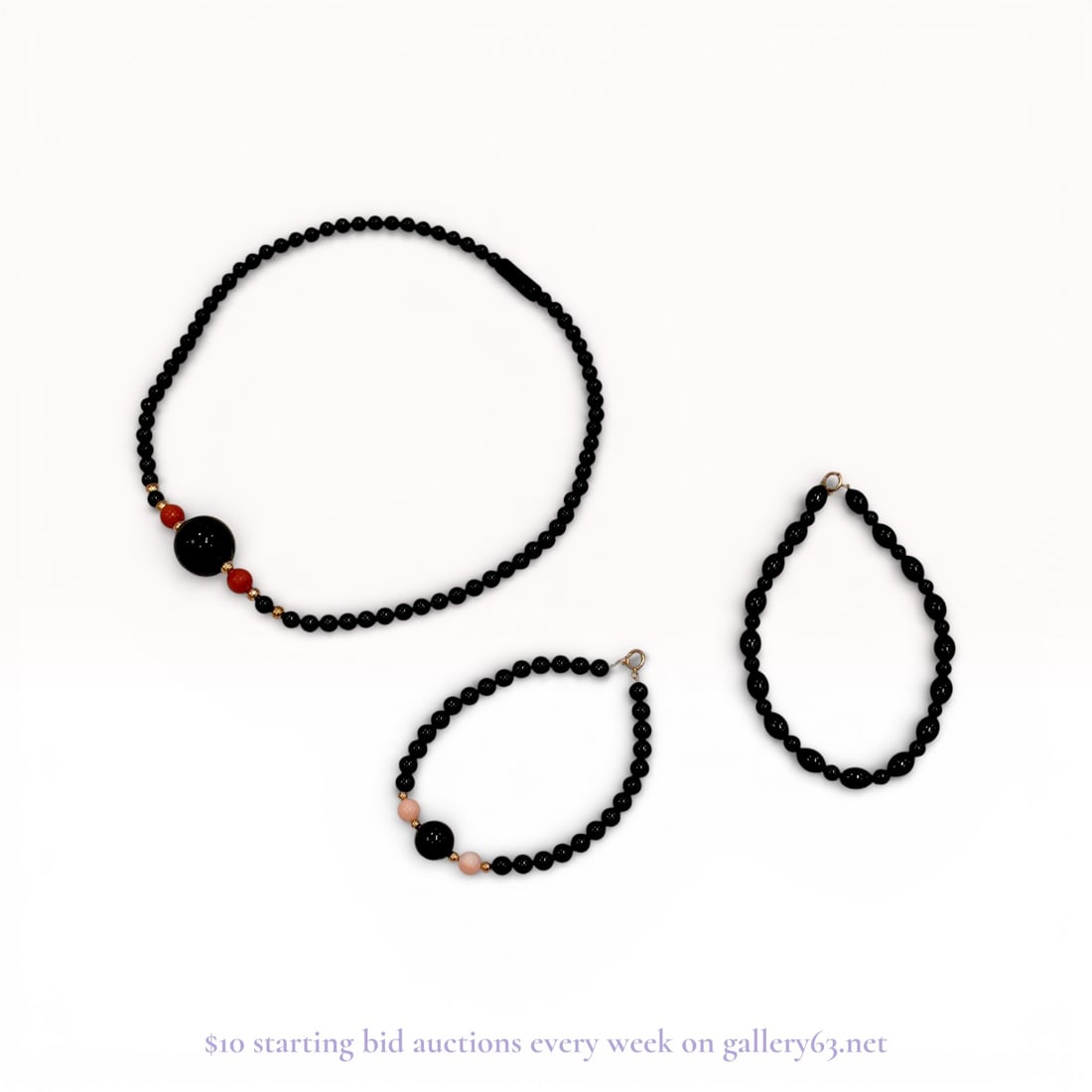 A Trio of Beaded Jewelry Including a Necklace and Two Bracelets: A trio of beaded jewelry featuring a necklace and two bracelets, late 20th century. The collection is composed of black beads consistent with onyx, accented by red and pink coral-colored beads and gol