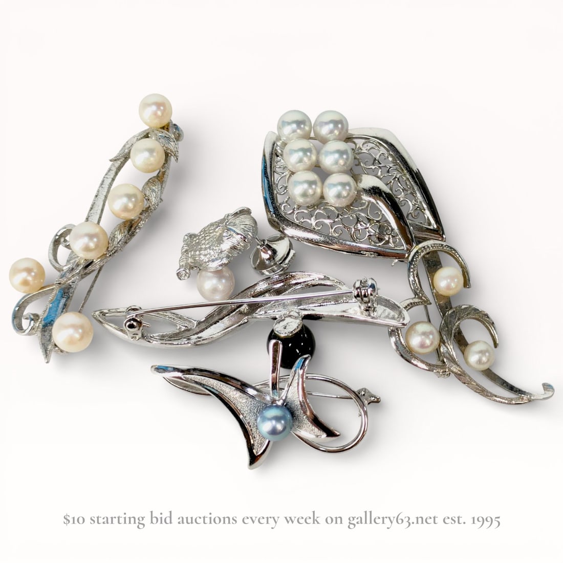 A Group of Six Vintage Silver-Toned and Cultured Pearl Brooches and Pins: A collection of six vintage silver-toned and cultured pearl brooches and pins, including a floral spray in the style of Mikimoto, mid-to-late 20th century. The assortment also features a filigree fan,