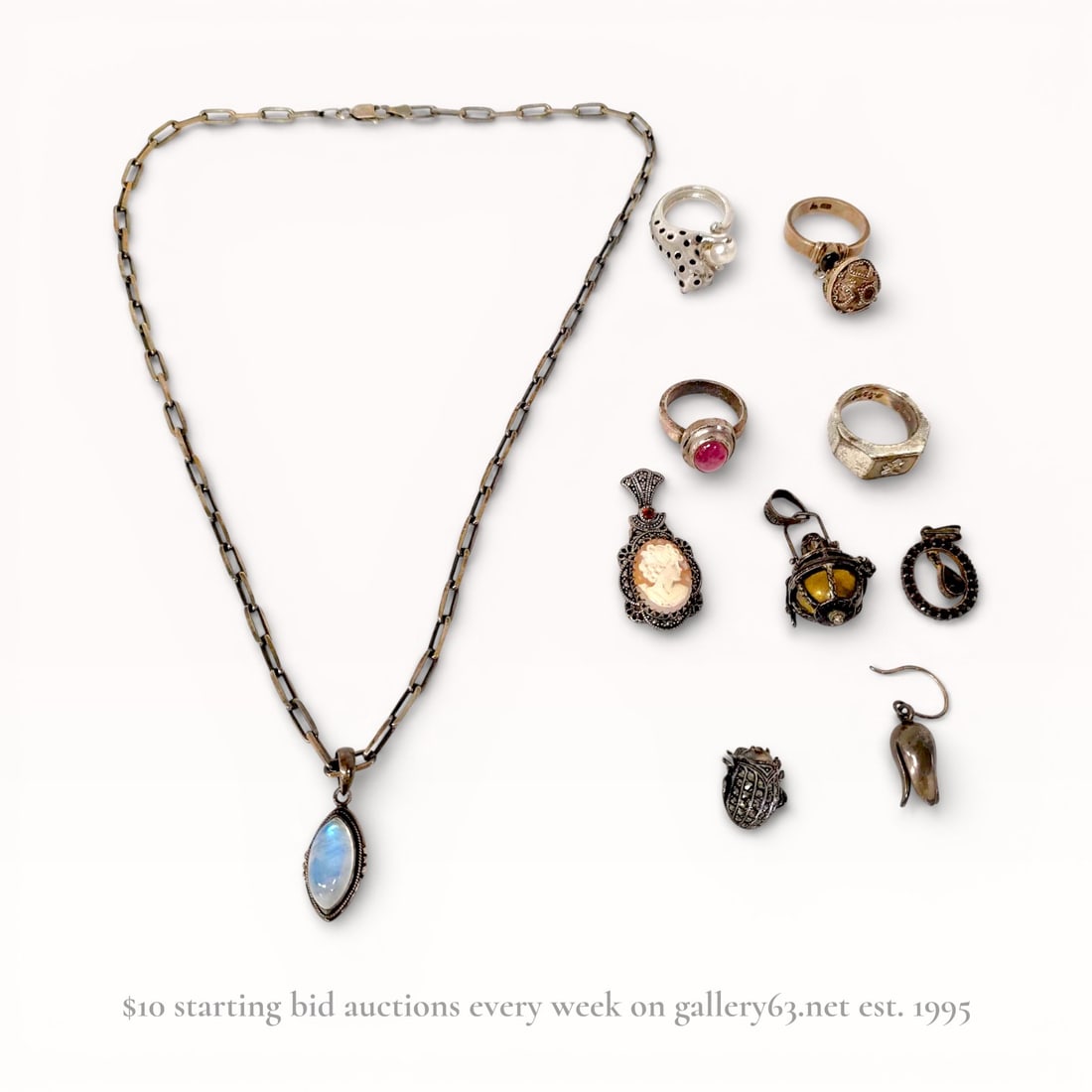 An Assortment of Vintage Sterling Silver Jewelry including Moonstone and Garnet: This collection features a sterling silver necklace with a marquise moonstone cabochon and a rectangular-link chain. Included are four rings: a panther bypass ring with a cultured pearl, a signet ring