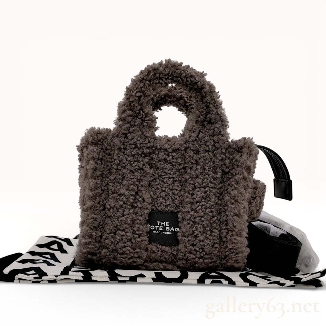 Marc Jacobs The Teddy Mini Tote Bag: Marc Jacobs The Teddy mini tote bag in charcoal gray faux-shearling fabric. The exterior features dual rolled top handles, a top zip closure with a leather-style pull, and a branded front patch. The i