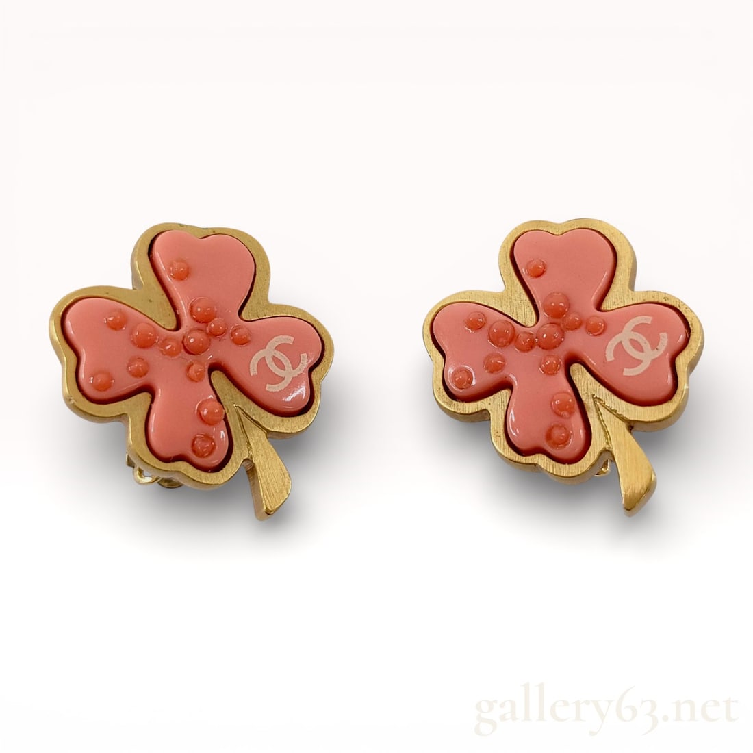 A Pair of Chanel Vintage 03P Pink Resin and Gold-Tone Clover Clip-On Earrings: Chanel clip-on earrings designed as stylized four-leaf clovers from the Spring 2003 collection. Each earring consists of a salmon-pink molded resin insert with raised circular granules and a white int
