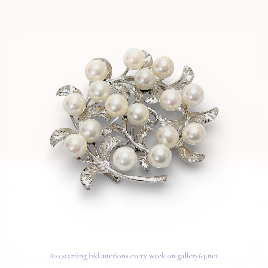 Mid-Century Japanese Cultured Pearl and Silver Foliate Brooch Pendant: Mid-century Japanese cultured pearl and silver foliate wreath brooch, featuring an integrated bail for use as a pendant. The circular design is composed of textured silver leaves set with eighteen rou