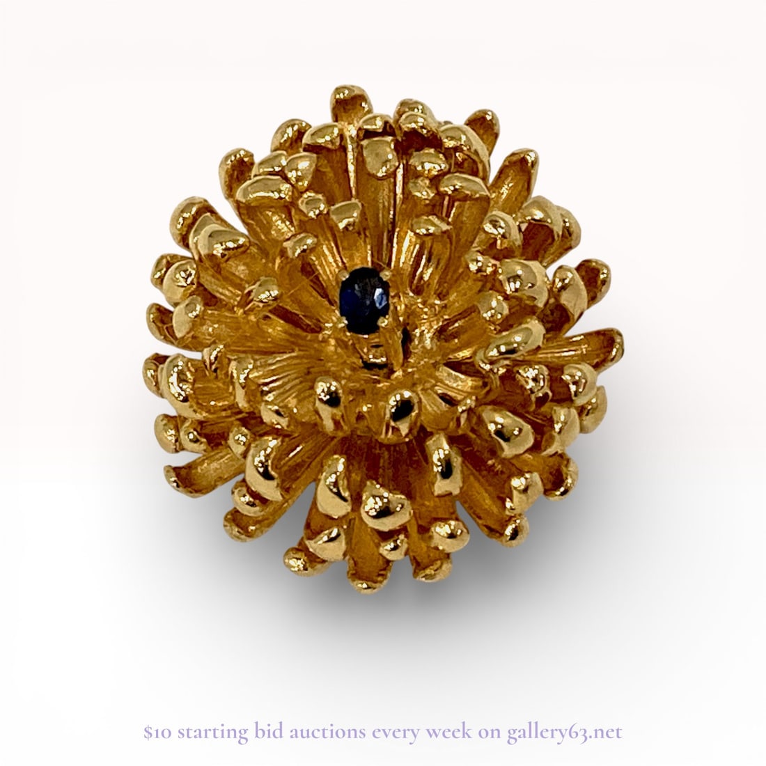 Vermeil and Sapphire Sea Anemone Style Floral Pendant: Vintage floral-form pendant by maker LEI, designed in a textured sea anemone or chrysanthemum style. The piece is crafted from gold-plated sterling silver featuring numerous radiating curved petals an