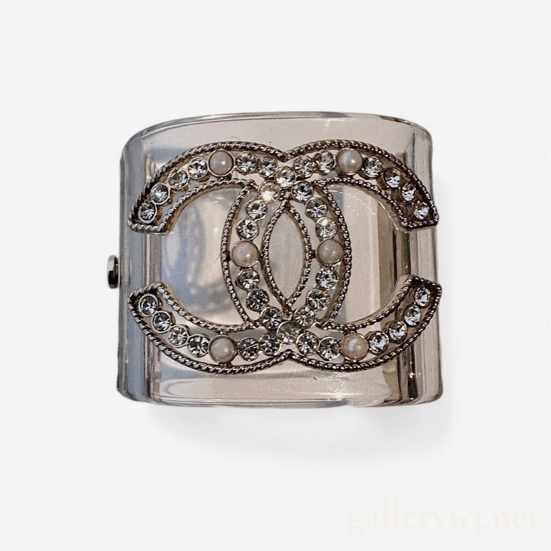Chanel 2019 Autumn Collection Clear Lucite and Crystal CC Wide Cuff Bracelet: Chanel clear resin and crystal CC wide cuff bracelet from the 2019 Autumn collection. The transparent resin body features a prominent gold-tone interlocking CC logo with a textured rope border, embell