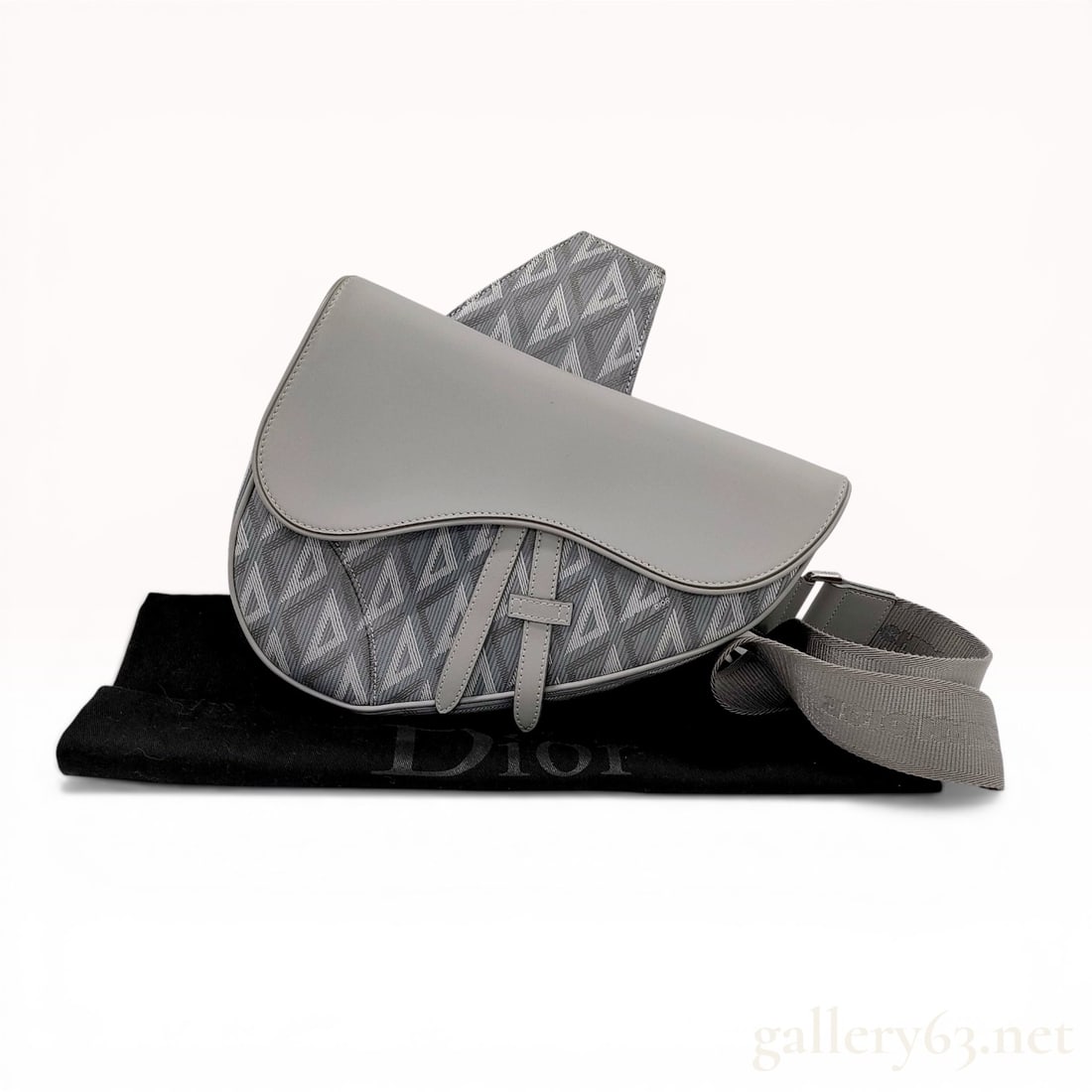 Dior CD Diamond Canvas Saddle Bag: Dior Men's Saddle Bag in Dior Gray CD Diamond canvas and smooth calfskin leather. This piece features an asymmetrical saddle silhouette with a magnetic flap closure, zippered main compartment, and an 