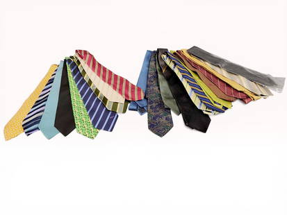 An Assortment of Eighteen Designer Silk Neckties including Hermes, Celine, and Versace: An assortment of eighteen designer silk neckties featuring luxury houses such as Hermes Paris, Celine Paris, Versace, and Burberry. The collection showcases a wide variety of patterns including