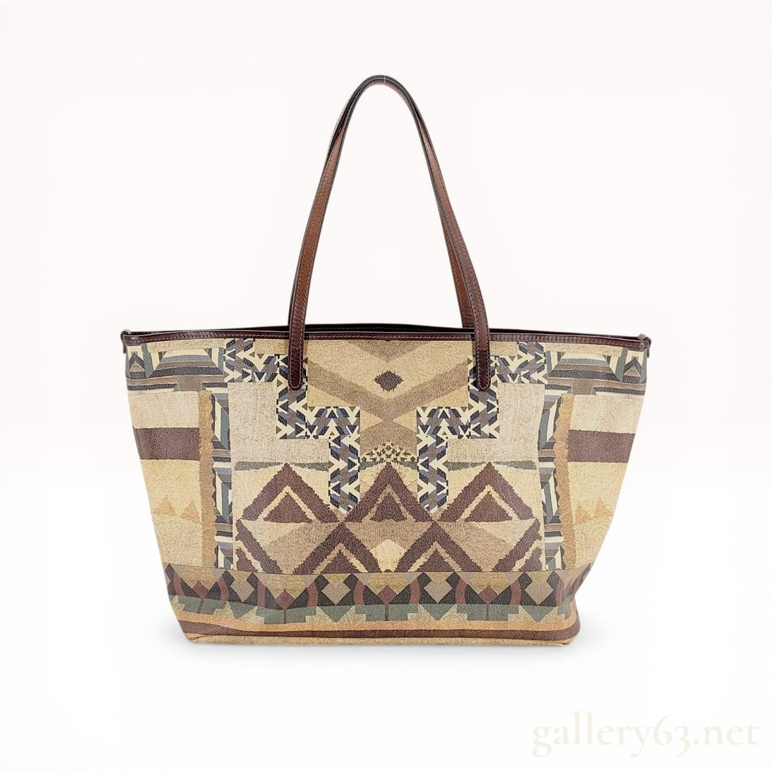 Southwestern Geometric Pattern Coated Canvas Tote Bag with Leather Trim: Southwestern style shopper tote, contemporary. Crafted from textured coated canvas featuring a geometric pattern in tan, brown, and teal with dark brown leather trim and shoulder straps. Interior is l