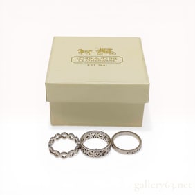 A Trio of Coach Sterling Silver Signature Stackable Rings