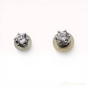 Pair of Platinum and Diamond Solitaire Stud Earrings: A matched pair of round brilliant-cut diamond solitaire stud earrings set in platinum. Each diamond is approximately 0.15 carats for a total weight of 0.30 carats, secured by classic six-prong
