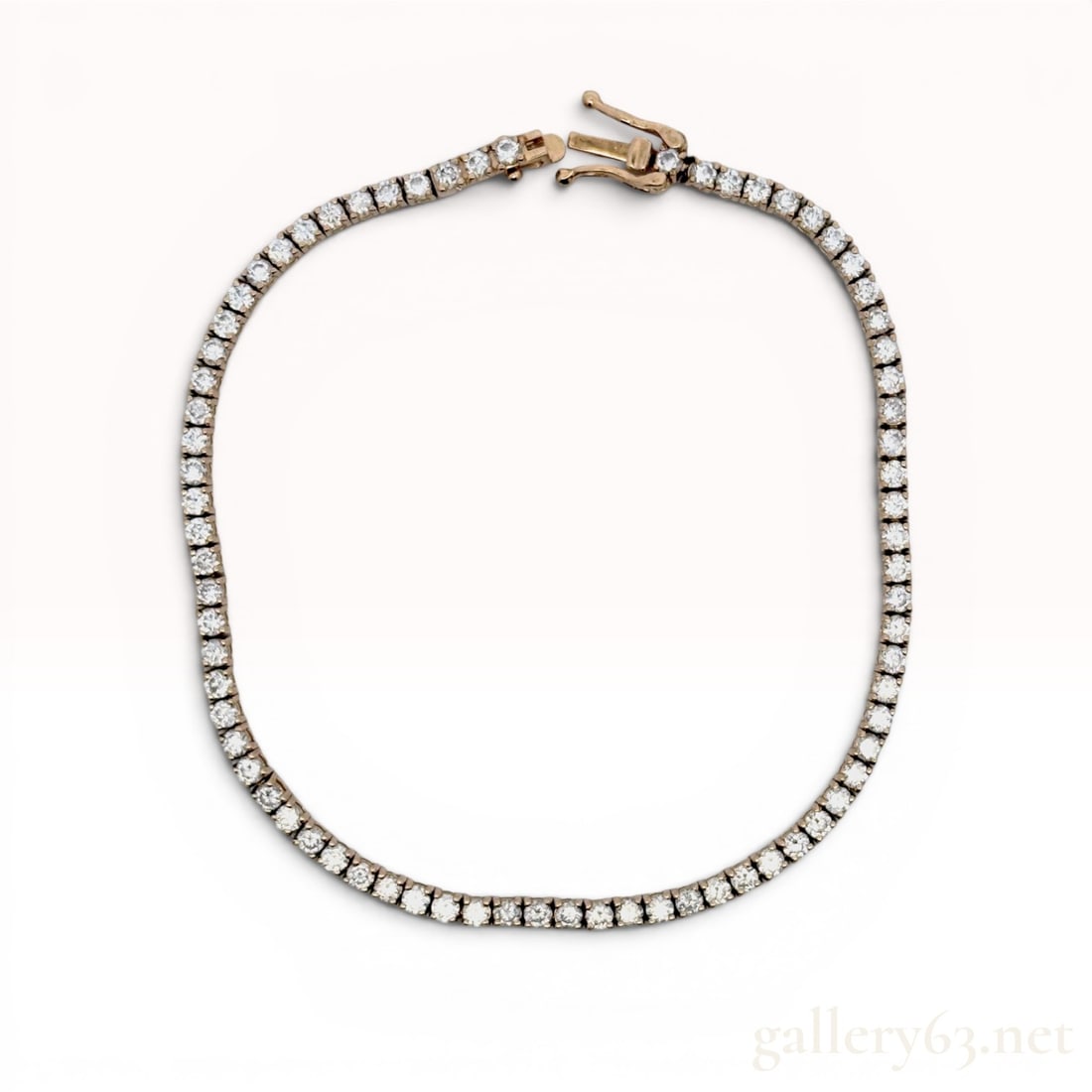 14K Yellow Gold and 2.00cttw Lab Grown Diamond Tennis Bracelet: 14 karat yellow gold tennis bracelet featuring round brilliant cut lab grown diamonds. The stones are individually set in four-prong square link mountings with an open-back design. It is secured by an