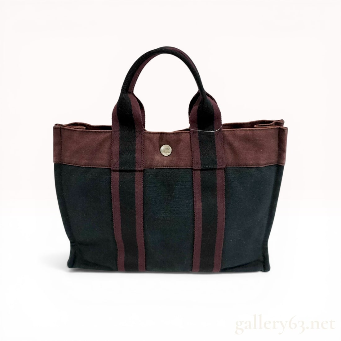 Hermes Fourre-Tout PM Bicolor Cotton Canvas Tote Bag: Hermes Fourre-Tout PM (Petit Modele) tote bag in a bicolor black and burgundy heavy-duty cotton canvas. The design features a burgundy top band with matching striped webbing handles that extend down t