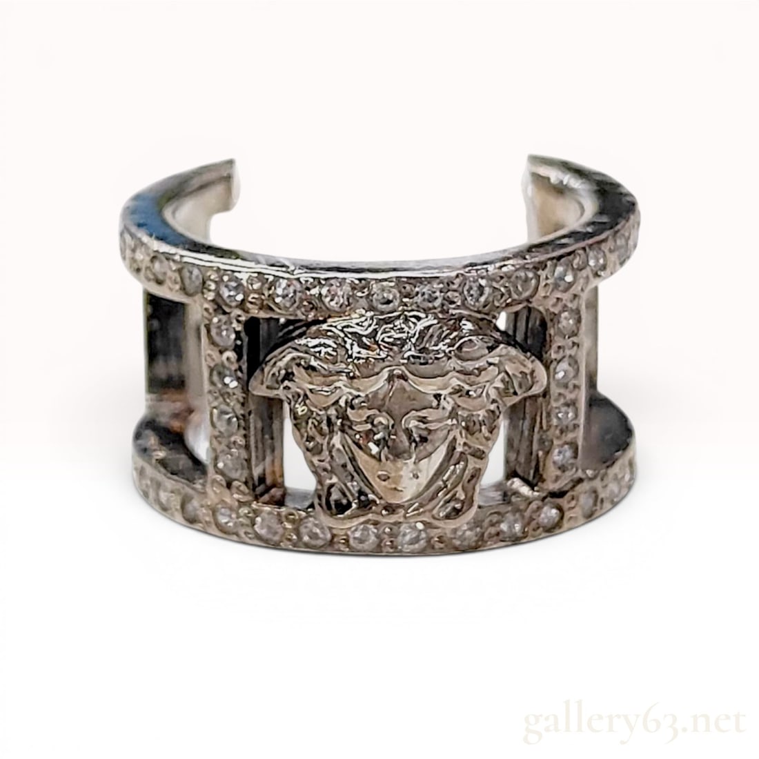 Versace Medusa Head Silver-Toned Openwork Statement Ring: Versace silver-toned wide-band statement ring featuring a central Medusa head motif. The openwork design is grain-set with numerous small round-cut clear crystals along the horizontal bands and vertic