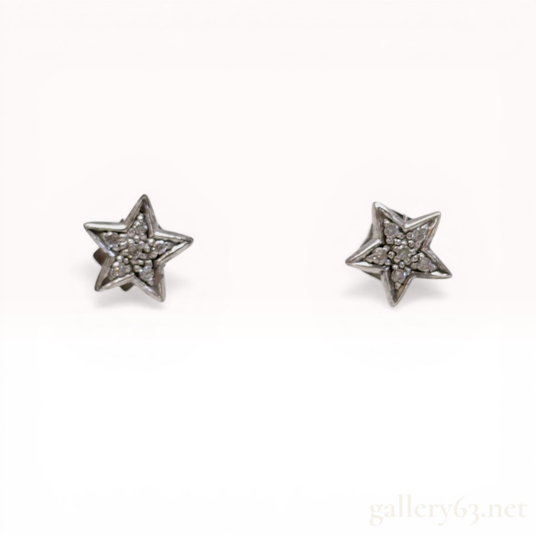 A Pair of Gucci Sterling Silver Pave Star Stud Earrings: A matched pair of Gucci star-shaped stud earrings crafted in .925 sterling silver. Each star is pave-set with multiple small colorless round-cut stones and features matching friction butterfly backing