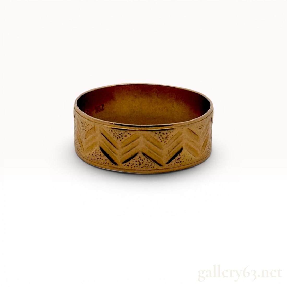 21K Yellow Gold Wide Chevron Patterned Band Ring size 10: A wide 21K yellow gold band ring featuring a continuous engraved chevron pattern around the exterior. The geometric design includes recessed areas with a fine stippled texture providing contrast to th