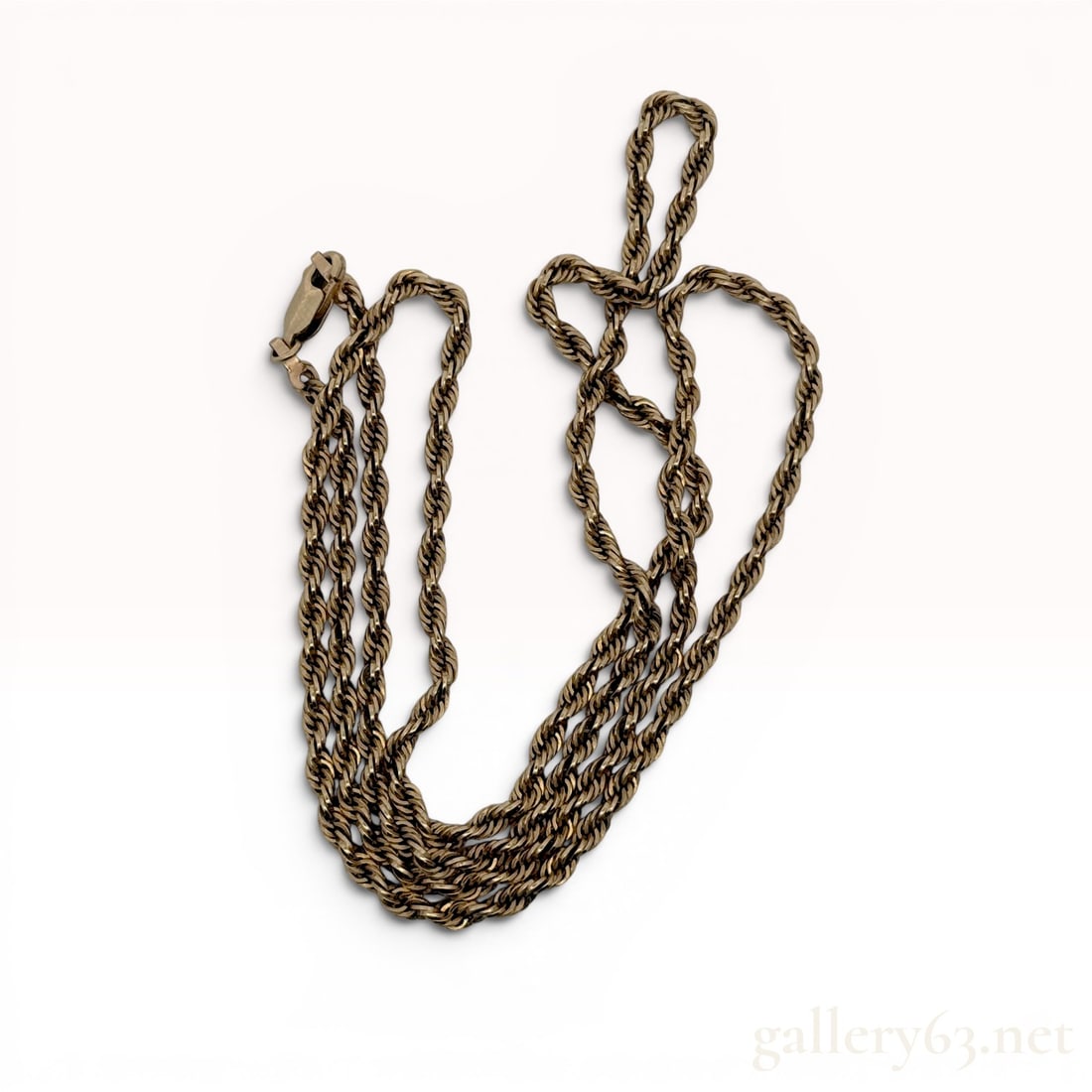 14K Yellow Gold Rope Chain Necklace 24': 14 karat yellow gold rope chain necklace featuring a classic twisted link design. The necklace is secured with a lobster claw clasp and a jump ring hallmark stamped 14K. The solid construction of the 