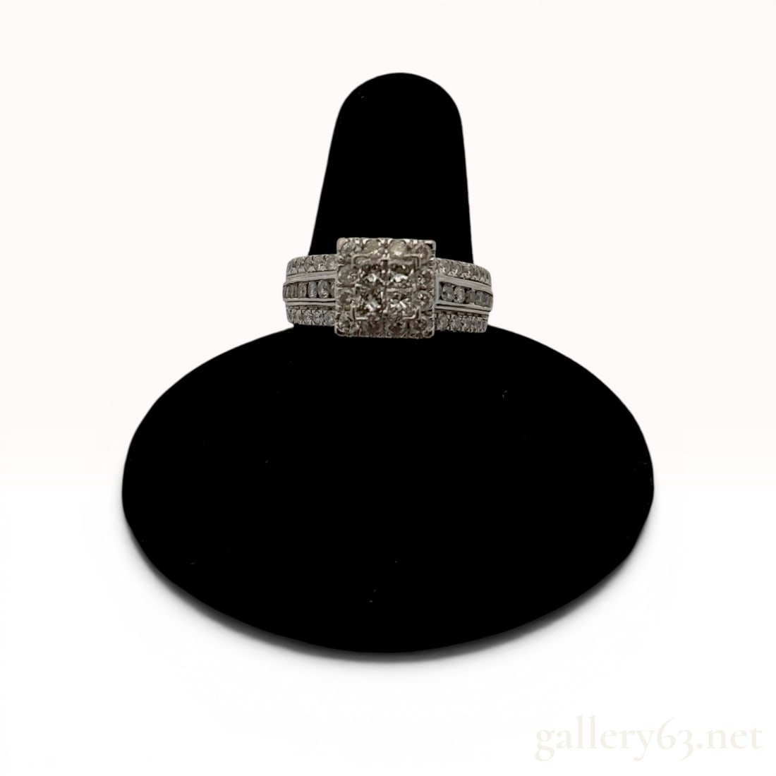 14 Karat White Gold and 1.25 cttw Diamond Ring: A diamond bridal-style ring in 14 karat white gold featuring a total weight of 1.25 carats. The design centers on a composite quad head of princess-cut diamonds with a round diamond halo and a wide sh