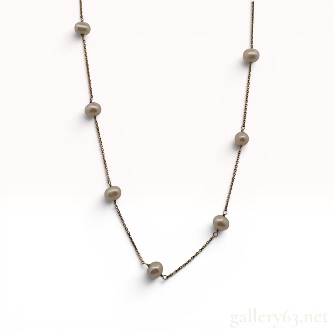 RCI 14K Yellow Gold and Freshwater Pearl Station Necklace 16': RCI 14 karat yellow gold station necklace featuring 11 cultured freshwater pearls. Each button to semi-baroque shaped pearl exhibits a pinkish-lavender luster and is individually wire-wrapped along a 