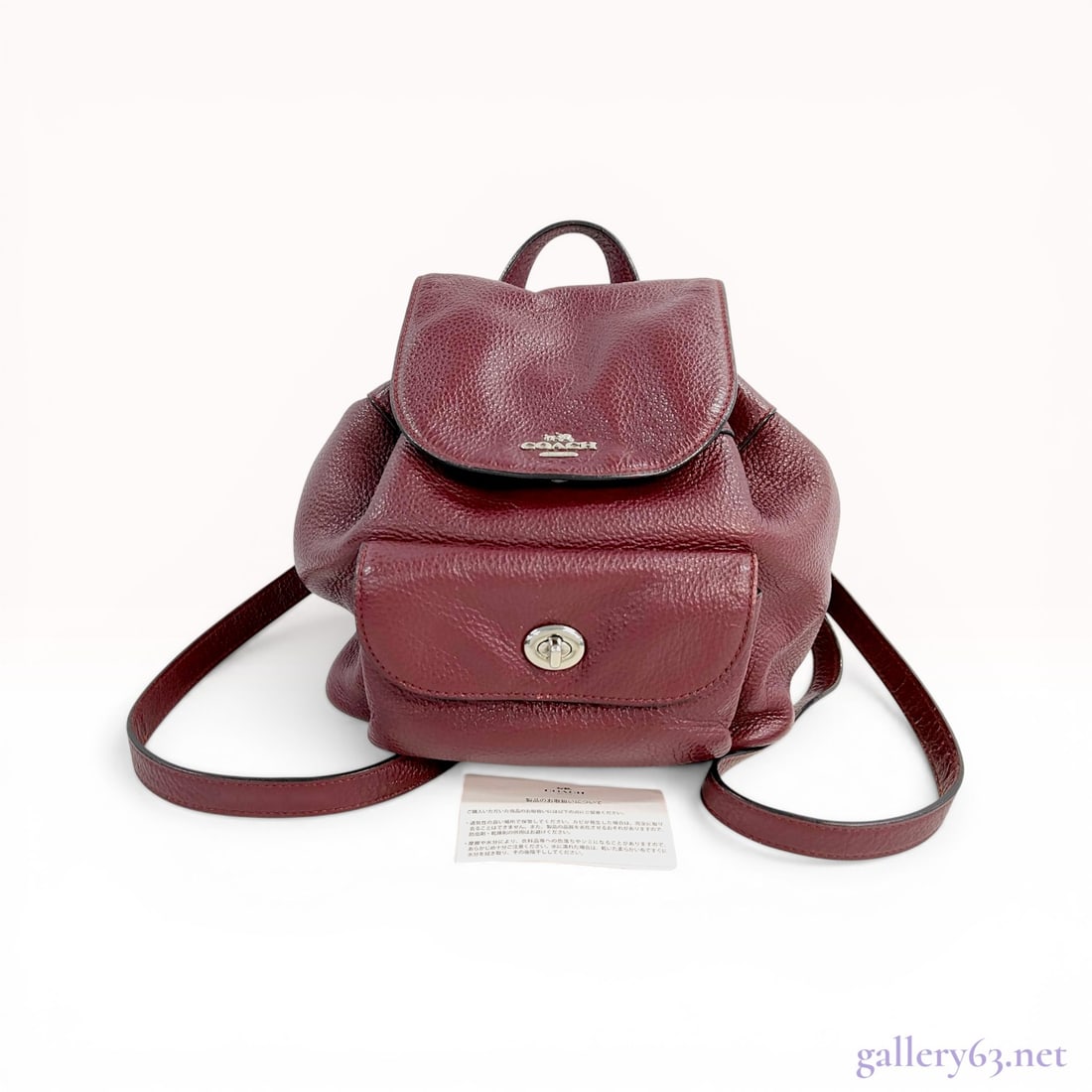 Coach Mini Billie Pebbled Leather Backpack in Burgundy: Coach Mini Billie backpack in burgundy pebbled leather. This item features a drawstring main compartment with a magnetic snap flap and a front exterior pocket with a silver-tone turn-lock closure. The